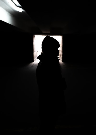 silhouette of person standing in room
